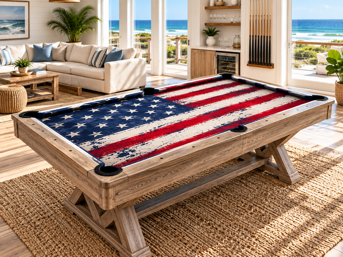 Close-up view of American flag custom pool table felt showing the printed cloth texture, pool table rails, corner pocket, cue sticks, and billiard balls.