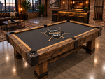 custom pool table felt shown on a traditional dark wood billiards table in a luxury game room with bar seating and warm lighting.